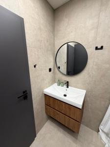 a bathroom with a sink and a mirror at Flora Hotel Apartment 103 in Borovets +6 photos