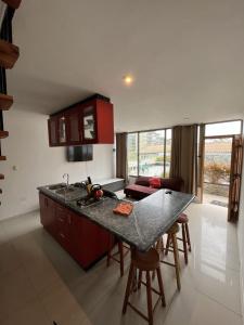 a kitchen with red cabinets and a counter top at La Quebrada lodge in Papudo