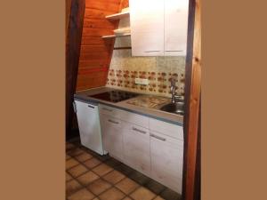 a kitchen with white cabinets and a sink at Charmantes Ferienhaus in Skigebietsnaehe in Schmallenberg