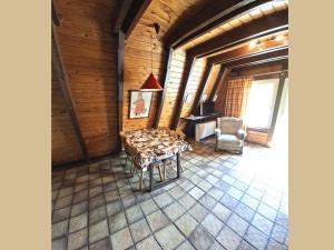 a living room with a table and a chair at Charmantes Ferienhaus in Skigebietsnaehe in Schmallenberg