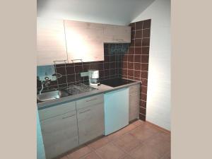 a small kitchen with a sink and a counter at Charmantes Ferienhaus in Skigebietsnähe in Schmallenberg