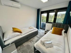 En eller flere senge i et værelse på Apartament LuMi