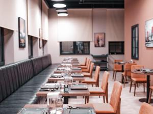 a row of tables and chairs in a restaurant at LIFESPORT-Complex Hotel & spa in Əlǝt