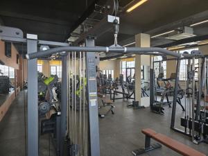 a gym with several rows of tread machines at LIFESPORT-Complex Hotel & spa in Əlǝt
