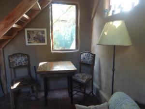 a room with a table and two chairs and a lamp at la remansa in Neptunia +20 photos