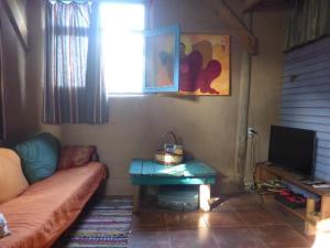 a living room with a couch and a table at la remansa in Neptunia