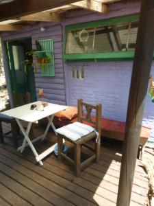 a table and chairs on the porch of a house at la remansa in Neptunia