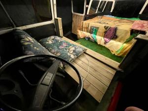 a small bedroom with a bed and a mirror at Kombi Home do Jardins in Imbituba
