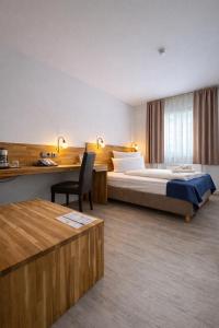 a hotel room with a bed and a desk at Hotel Stuttgart 21 in Stuttgart