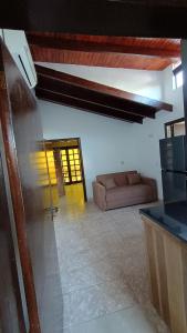 a living room with a couch in a room at Villa Loma in Caacupé