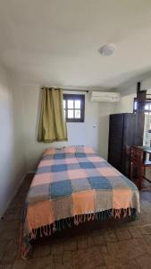 a bedroom with a bed in a room at Recanto dos Pássaros in Palhoça