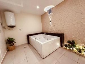 a bath tub in a bathroom with a water fountain at Giza Pyramids Inn in Cairo +32 photos