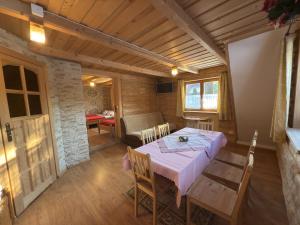a dining room with a pink table and chairs at Zakopane - Króle 16 in Zakopane