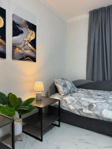 a bedroom with a bed and a table with a lamp at Comfort House Kocani in Kočani
