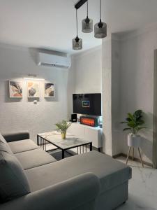 a living room with a couch and a table at Comfort House Kocani in Kočani