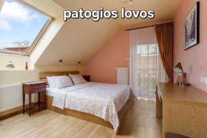 a bedroom with a bed and a window at Vila Liepa in Birštonas