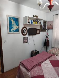 a bedroom with a bed and a tv on the wall at Família Jardim in São Gabriel +3 photos