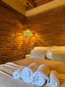 a bedroom with a bed with towels on it at Amambay in Puerto Bossetti +1 photo