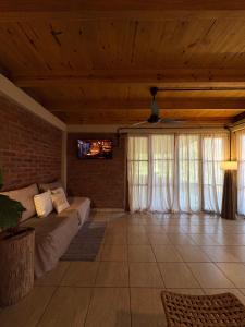 a living room with a couch and some windows at Amambay in Puerto Bossetti