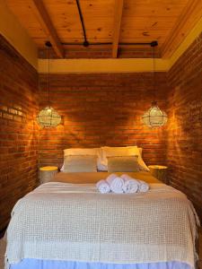 a bedroom with a bed with towels on it at Amambay in Puerto Bossetti
