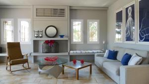 a living room with a couch and a table at Pentathlon Villa Collection - Porto Cheli Private Pool Getaways in Porto Heli