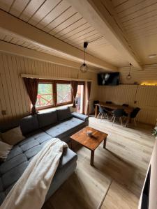 a living room with a couch and a table at Chata Dolce Donovaly in Donovaly