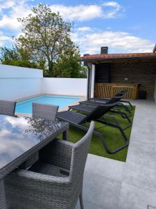 a patio with a table and chairs and a pool at Casa de Campelo in Vila Nova de Cerveira