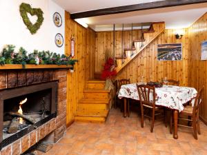 a dining room with a fireplace and a table and chairs at LA GROTTA Guest House Subiaco in Subiaco