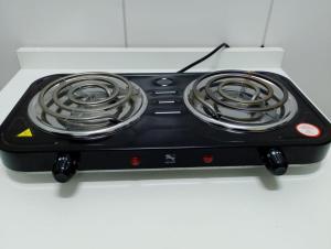 a black stove top oven with coils on it at Cantinho do Sossego in Indaiatuba