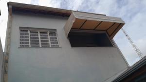 a window on the side of a white building at Cantinho do Sossego in Indaiatuba