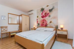 ein Schlafzimmer mit einem Bett und einem Gemälde an der Wand in der Unterkunft Guesthouse Casa Nova in Poreč