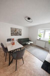a living room with a table and a couch at Munich Premium Guesthouse in Munich