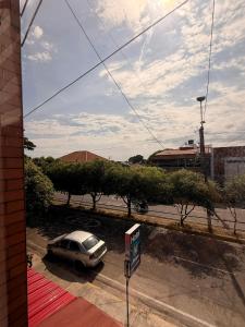 a car parked in a parking lot next to a street at Hotel Atalayas in Yopal