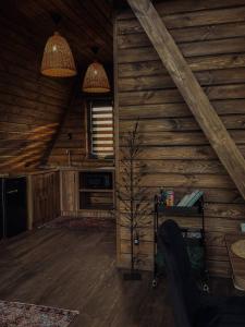a log cabin with two lights and a table in a room at Aframe Shepit in Sosnovka