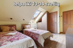 a bedroom with two beds and a window at Vila Liepa in Birštonas +47 photos