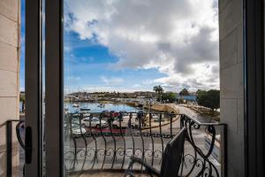a balcony with a view of a harbor with boats at Silver Harbour - 2 Bedrooms, 2 Bathrooms in Il-Gżira