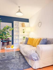 a living room with a couch and a table at Comfortable 3-Bed House near Canterbury Centre in Canterbury