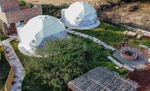an aerial view of a garden with two domes at Aldea Hualtepec Glamping in Huichapan
