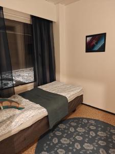 a bedroom with two beds and a window at Patomajat in Rovaniemi +17 photos