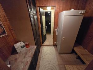 a hallway with a small refrigerator in a room at Patomajat in Rovaniemi