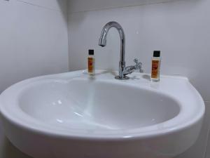 a white sink with a faucet in a bathroom at Cataratas Loft Residence in Foz do Iguaçu +26 photos