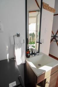 a bathroom with a sink and a mirror at Aldea Hualtepec Glamping in Huichapan +20 photos