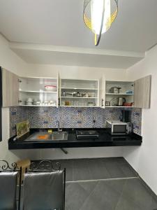 a kitchen with a counter top with a microwave at Wavera Surf Camp in Imsouane +75 photos