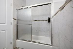a shower with a glass door in a bathroom at 3 BR • Full Kitchen • Sleeps 8 in Jersey City