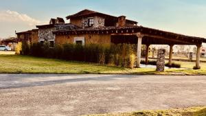an old house with a porch in front of it at Casa La Patrona in Santeagueda