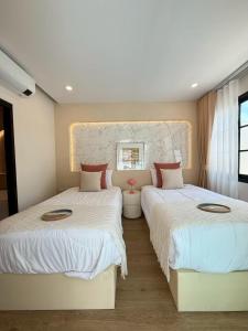 Postel nebo postele na pokoji v ubytování La Perle Villa