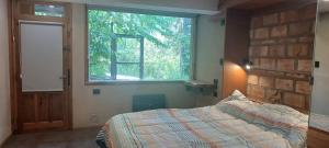 En eller flere senge i et værelse på Cabañas km7 Bariloche