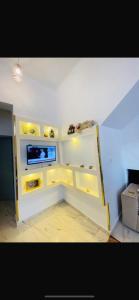a living room with a tv and a white shelf at Hadi Guest House in Luxor +9 photos