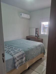 En eller flere senge i et værelse på Casa Temporada Torres