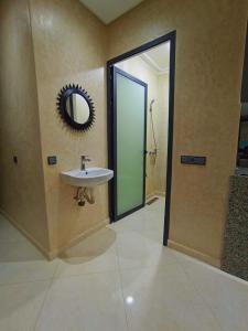 a bathroom with a sink and a mirror on the wall at Blue Wave Surf House in Mirleft +35 photos